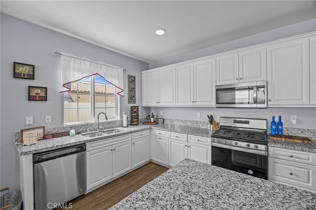 24909 Miners View Ln, Moreno Valley, CA 92557 - kitchen with stainless steel appliances, dark wood-style floors, white cabinets, light stone countertops, and recessed lighting