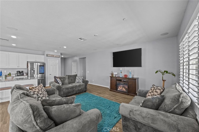 24909 Miners View Ln, Moreno Valley, CA 92557 - living area featuring wood finished floors and recessed lighting