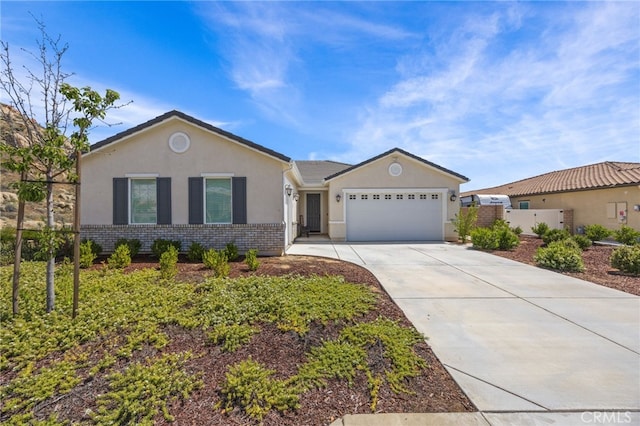 24909 Miners View Ln, Moreno Valley, CA 92557 - ranch-style home with stucco siding, a garage, concrete driveway, and brick siding