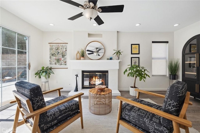 28034 Parkridge Ln, Canyon Country, CA 91387 - living room featuring a ceiling fan, a glass covered fireplace, recessed lighting, and wood finished floors