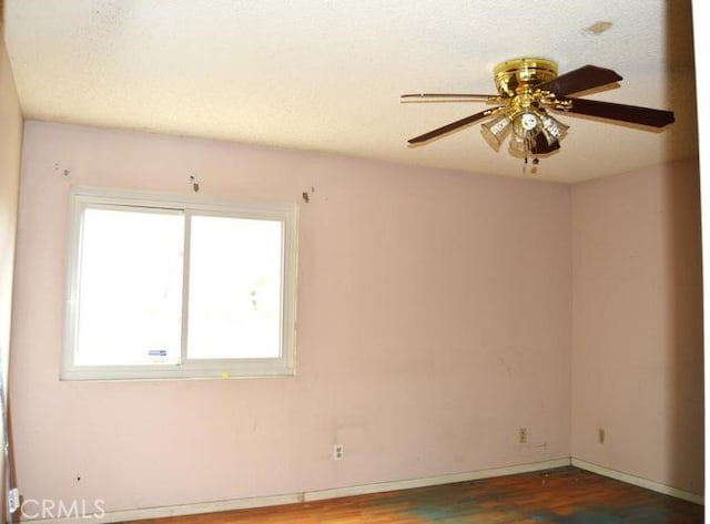 12077 Swegles Ln, Moreno Valley, CA 92557 - spare room with wood finished floors, a ceiling fan, and baseboards