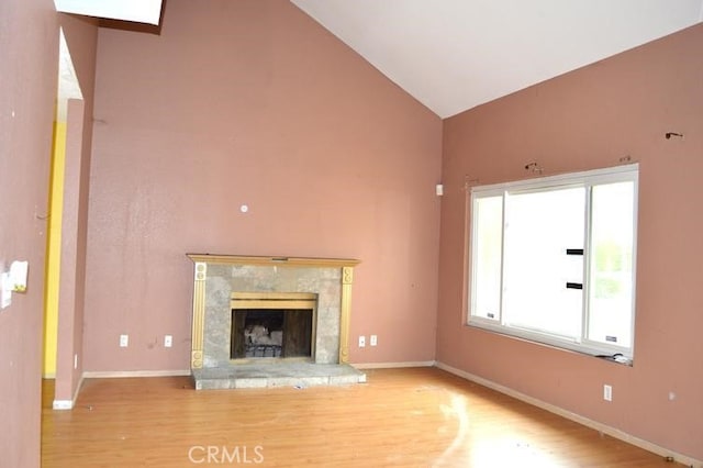 12077 Swegles Ln, Moreno Valley, CA 92557 - unfurnished living room featuring high vaulted ceiling, wood finished floors, a fireplace, and baseboards