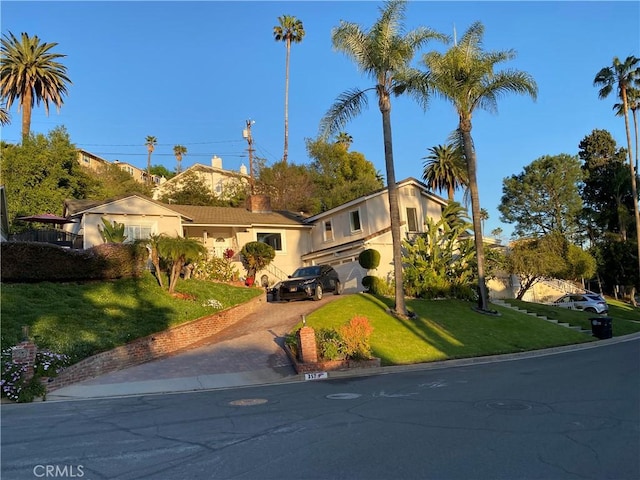 357 Cumberland Rd, Glendale, CA 91202 - view of front of home with driveway, a front yard, and a chimney