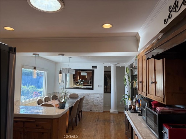 357 Cumberland Rd, Glendale, CA 91202 - kitchen featuring tile countertops, ornate columns, wood finished floors, open shelves, and crown molding