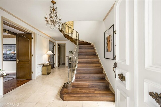 508 Evening Star Ln, Newport Beach, CA 92660 - stairway featuring tile patterned floors and a chandelier