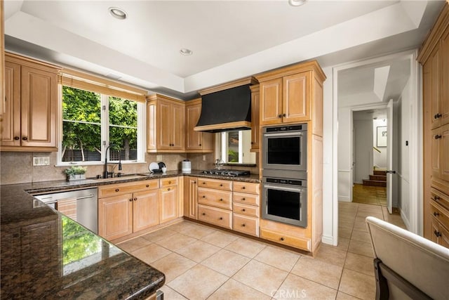 508 Evening Star Ln, Newport Beach, CA 92660 - kitchen with premium range hood, appliances with stainless steel finishes, light tile patterned floors, backsplash, and a tray ceiling