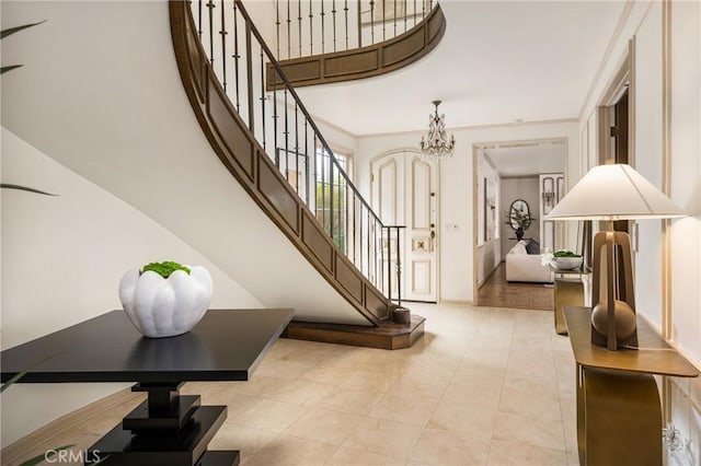 508 Evening Star Ln, Newport Beach, CA 92660 - stairs featuring a chandelier, a towering ceiling, baseboards, and tile patterned floors