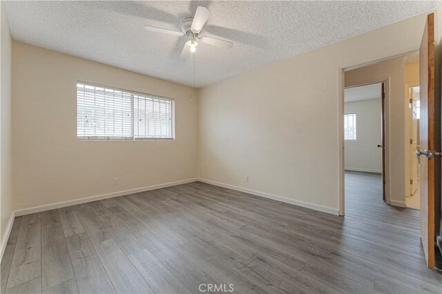 4820 Eagle St, Los Angeles, CA 90022 - spare room featuring a textured ceiling, ceiling fan, wood finished floors, and baseboards