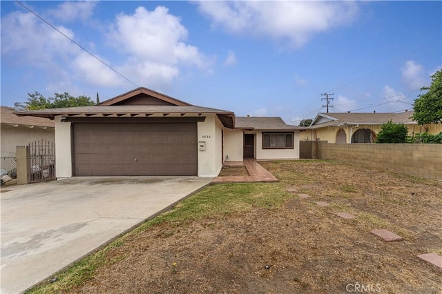 4820 Eagle St, Los Angeles, CA 90022 - ranch-style home with stucco siding, an attached garage, and concrete driveway
