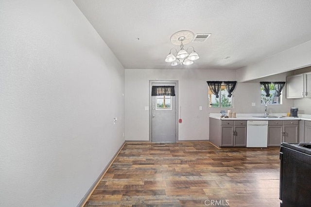 5150 N Berkeley Ave, San Bernardino, CA 92407 - kitchen featuring white dishwasher, stove, dark wood finished floors, gray cabinetry, and a chandelier