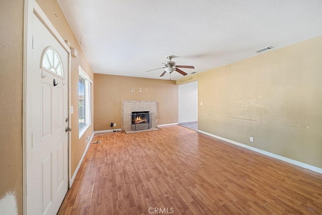 5150 N Berkeley Ave, San Bernardino, CA 92407 - unfurnished living room with light wood-style floors, a ceiling fan, and a fireplace with flush hearth