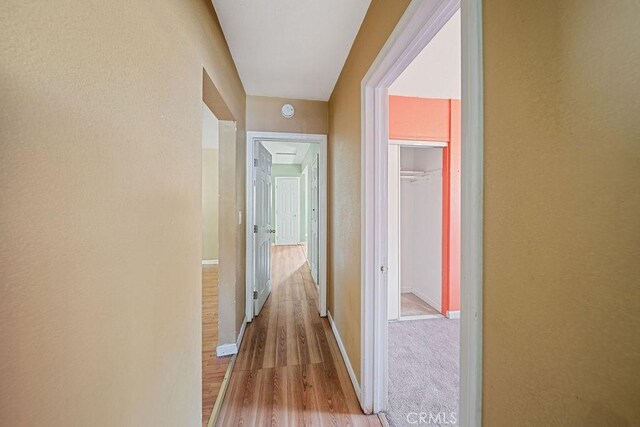 5150 N Berkeley Ave, San Bernardino, CA 92407 - corridor featuring wood finished floors and baseboards