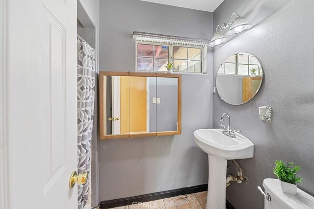 5150 N Berkeley Ave, San Bernardino, CA 92407 - bathroom with toilet and baseboards