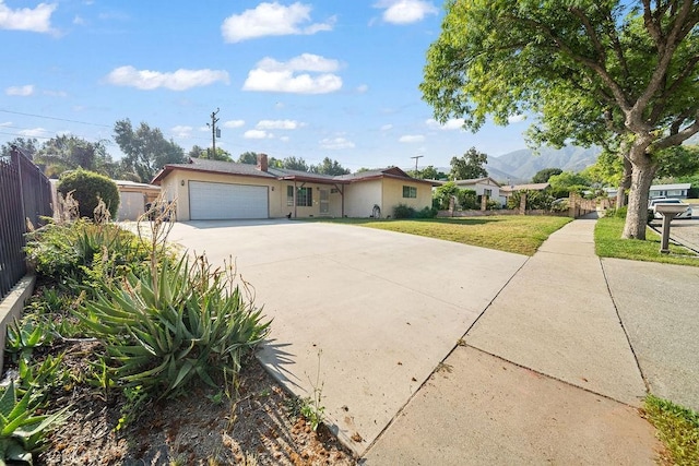 5150 N Berkeley Ave, San Bernardino, CA 92407 - ranch-style house featuring concrete driveway, an attached garage, and stucco siding