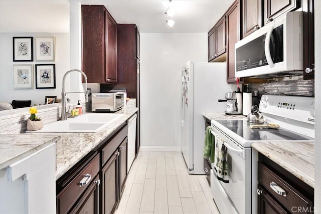 898 Temple Unit 125, Los Angeles, CA 90042 - kitchen featuring white appliances, a sink, baseboards, backsplash, and light stone countertops