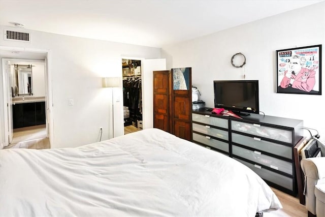 898 Temple Unit 125, Los Angeles, CA 90042 - bedroom featuring a spacious closet, a closet, wood finished floors, and ensuite bath