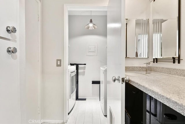 898 Temple Unit 125, Los Angeles, CA 90042 - bathroom featuring vanity, washer / dryer, and baseboards