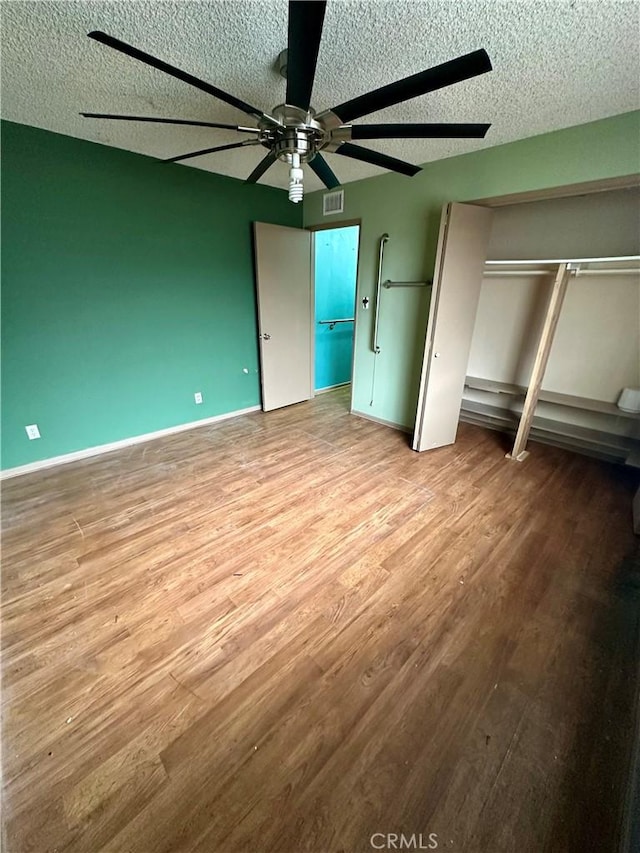 1947 Palm Ave, Monterey Park, CA 91755 - unfurnished bedroom featuring wood finished floors, a textured ceiling, ceiling fan, a closet, and baseboards