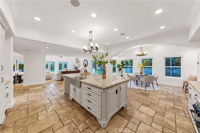 25811 Jamon Ln, Mission Viejo, CA 92691 - kitchen with a chandelier, open floor plan, arched walkways, stone tile flooring, and dishwasher