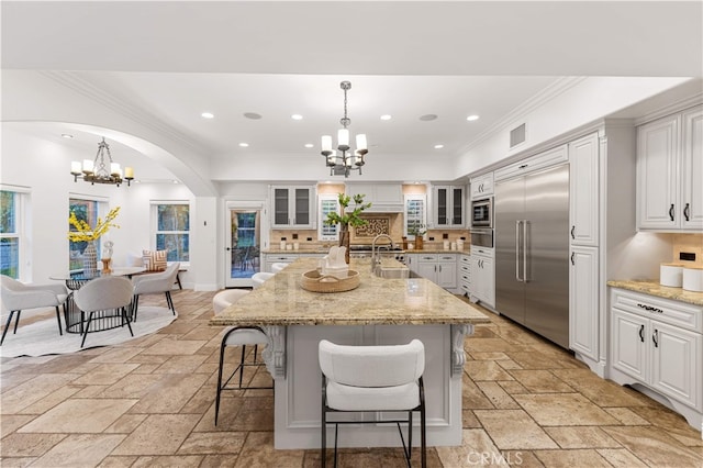 25811 Jamon Ln, Mission Viejo, CA 92691 - kitchen with built in appliances, a chandelier, stone tile flooring, tasteful backsplash, and recessed lighting
