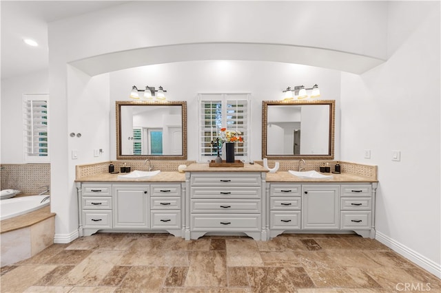 25811 Jamon Ln, Mission Viejo, CA 92691 - full bathroom featuring double vanity, a garden tub, and tasteful backsplash