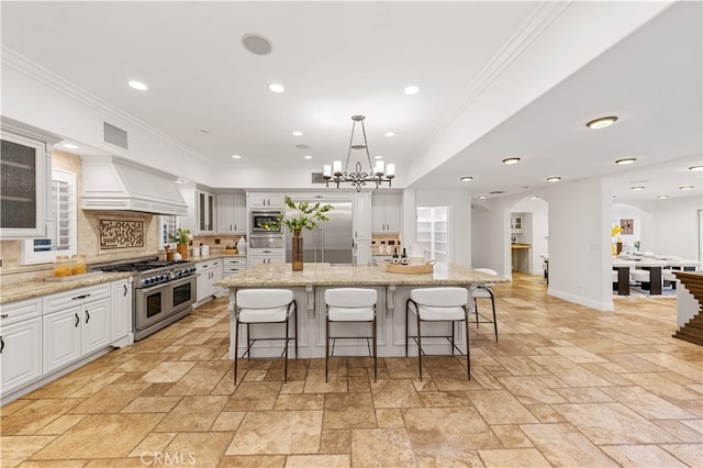 25811 Jamon Ln, Mission Viejo, CA 92691 - kitchen featuring built in appliances, custom exhaust hood, stone tile floors, white cabinets, and crown molding
