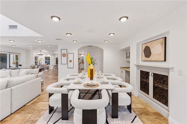 25811 Jamon Ln, Mission Viejo, CA 92691 - dining area featuring arched walkways, recessed lighting, and a chandelier
