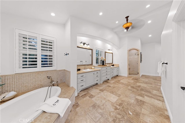 25811 Jamon Ln, Mission Viejo, CA 92691 - bathroom with double vanity, a stall shower, a garden tub, stone tile flooring, and recessed lighting