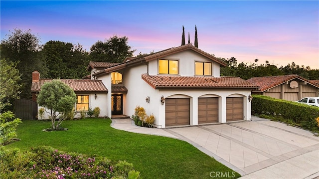 25811 Jamon Ln, Mission Viejo, CA 92691 - mediterranean / spanish house featuring driveway, french doors, a tiled roof, a yard, and stucco siding