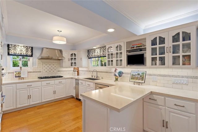 2136 W Gaucho Dr, Rancho Palos Verdes, CA 90275 - kitchen with a sink, wall chimney range hood, ornamental molding, a peninsula, and a raised ceiling