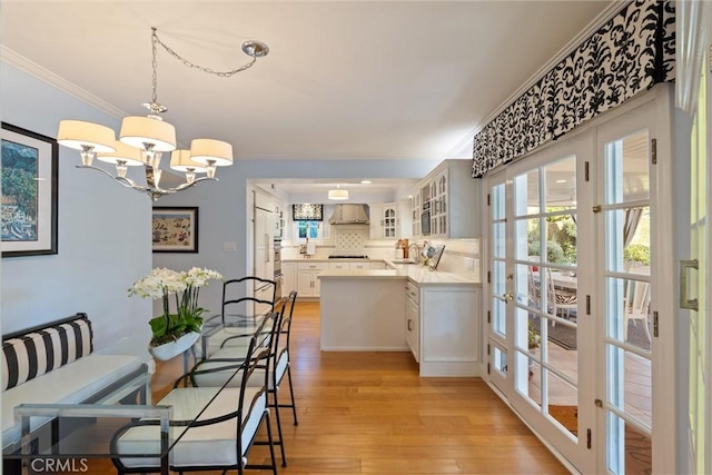 2136 W Gaucho Dr, Rancho Palos Verdes, CA 90275 - dining area with ornamental molding, light wood-style floors, a chandelier, and plenty of natural light