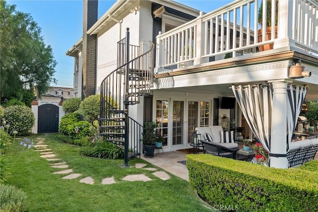 2136 W Gaucho Dr, Rancho Palos Verdes, CA 90275 - back of house featuring stairs, a balcony, a chimney, stucco siding, and a lawn