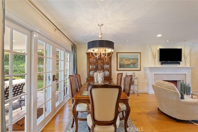 2136 W Gaucho Dr, Rancho Palos Verdes, CA 90275 - dining space with a chandelier, light wood-type flooring, a fireplace, crown molding, and baseboards