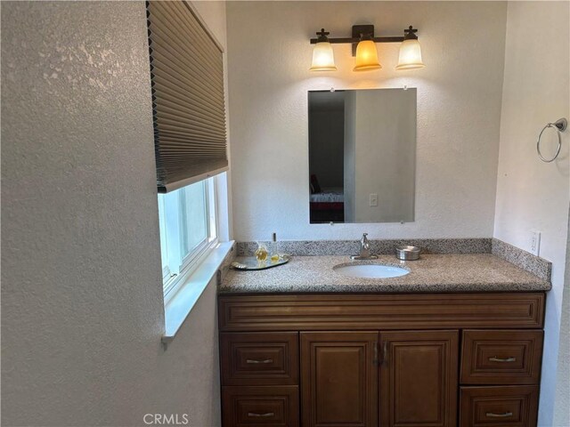 2770 Cole Ave, Highland, CA 92346 - bathroom with vanity and a textured wall