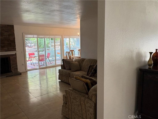 2770 Cole Ave, Highland, CA 92346 - tiled living area featuring a textured ceiling, a large fireplace, and a textured wall