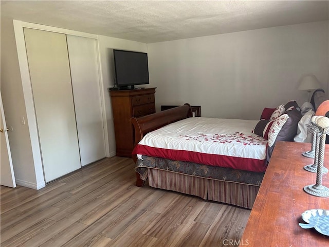 2770 Cole Ave, Highland, CA 92346 - bedroom with wood finished floors, a textured ceiling, and a closet