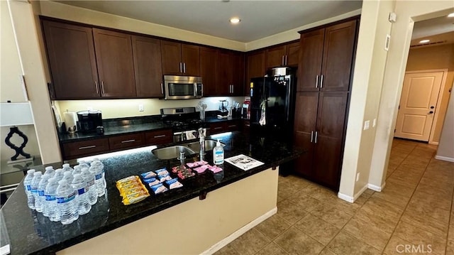 1502 Beacon, Upland, CA 91786 - kitchen featuring appliances with stainless steel finishes, light tile patterned floors, dark brown cabinetry, recessed lighting, and dark stone countertops