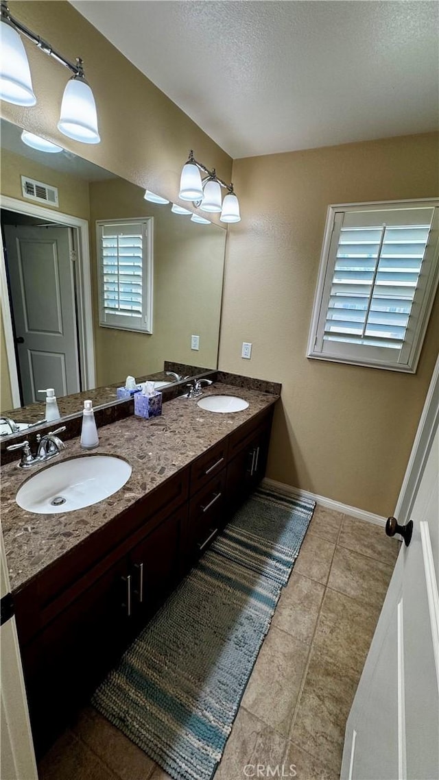 1502 Beacon, Upland, CA 91786 - bathroom with double vanity, tile patterned floors, and a textured ceiling