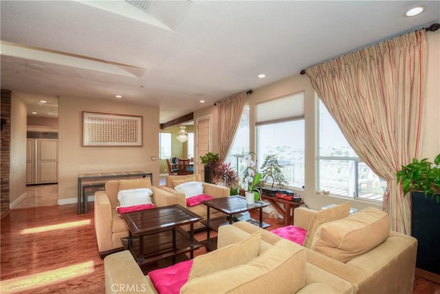 8140 Del Ct, Phelan, CA 92371 - living area with healthy amount of natural light, wood finished floors, recessed lighting, and baseboards