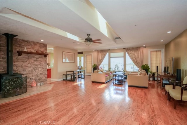 8140 Del Ct, Phelan, CA 92371 - living area featuring wood finished floors, a wood stove, recessed lighting, a ceiling fan, and baseboards