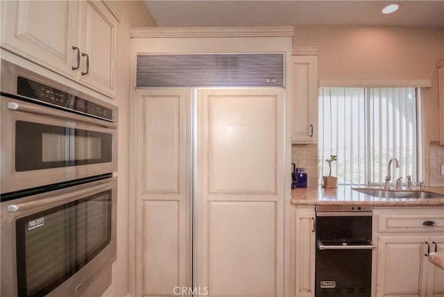 8140 Del Ct, Phelan, CA 92371 - kitchen featuring double oven, a sink, paneled built in refrigerator, light stone countertops, and backsplash