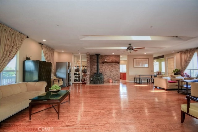 8140 Del Ct, Phelan, CA 92371 - living area featuring a wood stove, wood finished floors, ceiling fan, and recessed lighting