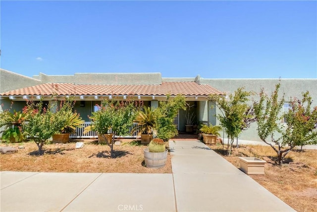 8140 Del Ct, Phelan, CA 92371 - southwest-style home featuring a tile roof, covered porch, and stucco siding