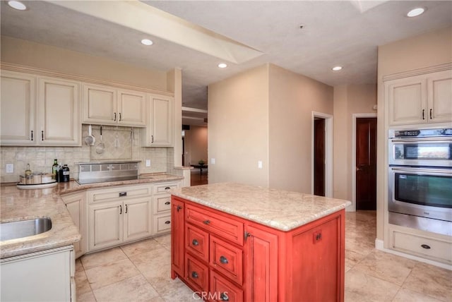 8140 Del Ct, Phelan, CA 92371 - kitchen with double oven, backsplash, recessed lighting, light stone countertops, and a kitchen island