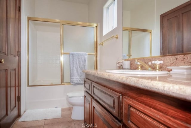 8140 Del Ct, Phelan, CA 92371 - bathroom featuring vanity, toilet, shower / bath combination with glass door, and tile patterned floors