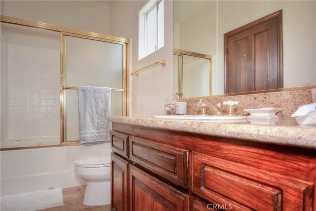 8140 Del Ct, Phelan, CA 92371 - bathroom featuring toilet, vanity, and bath / shower combo with glass door