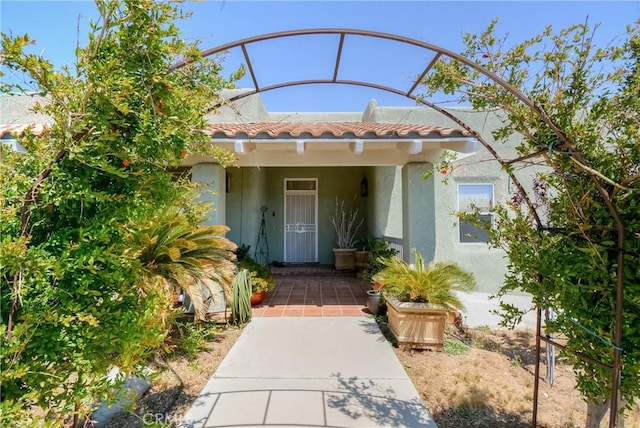 8140 Del Ct, Phelan, CA 92371 - property entrance featuring a tiled roof and stucco siding