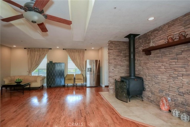 8140 Del Ct, Phelan, CA 92371 - unfurnished living room featuring a wood stove, wood finished floors, ceiling fan, and recessed lighting