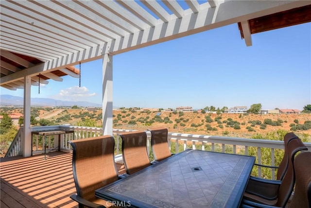 8140 Del Ct, Phelan, CA 92371 - wooden terrace with outdoor dining area, a pergola, and a mountain view