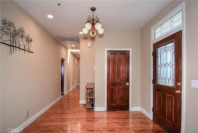 8140 Del Ct, Phelan, CA 92371 - entryway featuring wood finished floors, a chandelier, recessed lighting, and baseboards